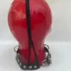 Rear view of red latex hood with zipper and protective guard