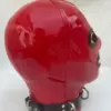 Side view of red rubber bondage mask showing metal D-rings