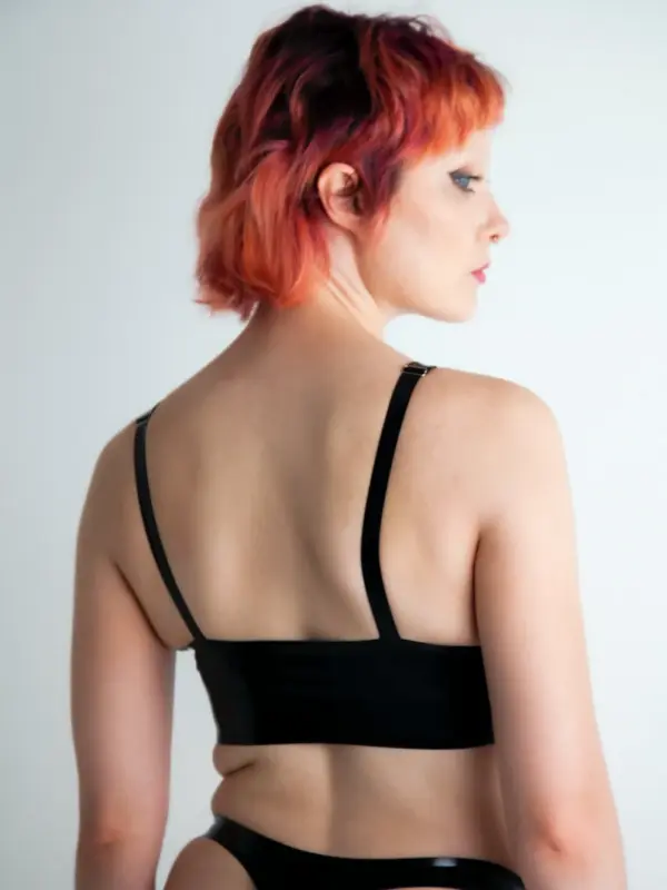 Model wearing sleek rubber fetish bra showing seamless pull-on fit and U-neckline