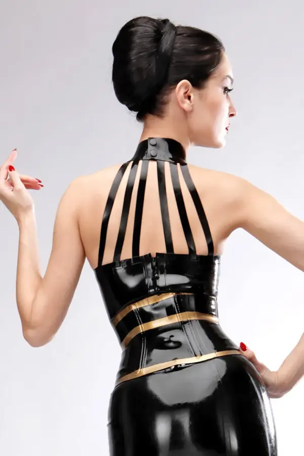 Model wearing elegant rubber harness top showing strappy collar design and dual snap buttons