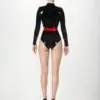 Rear view of black and red rubber uniform showing back zipper