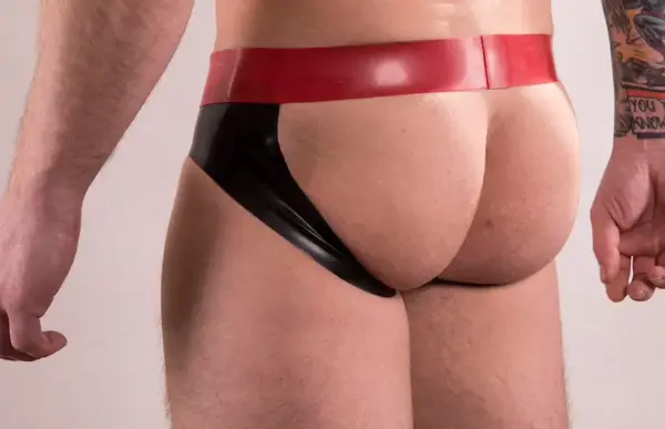 Rear view of open back latex briefs with red waistband