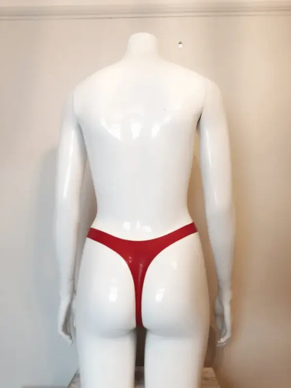 Model wearing playful rubber fetish high waist thong showing cute heart negative space