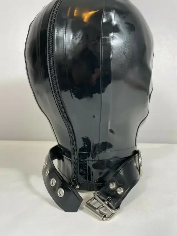 Side view of bondage rubber mask with perforated eyes and open mouth