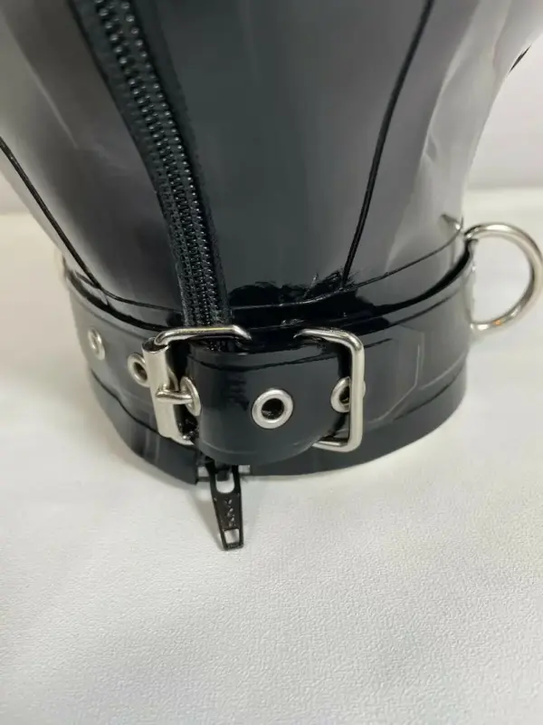 Close up of integrated collar with D-rings on black latex hood