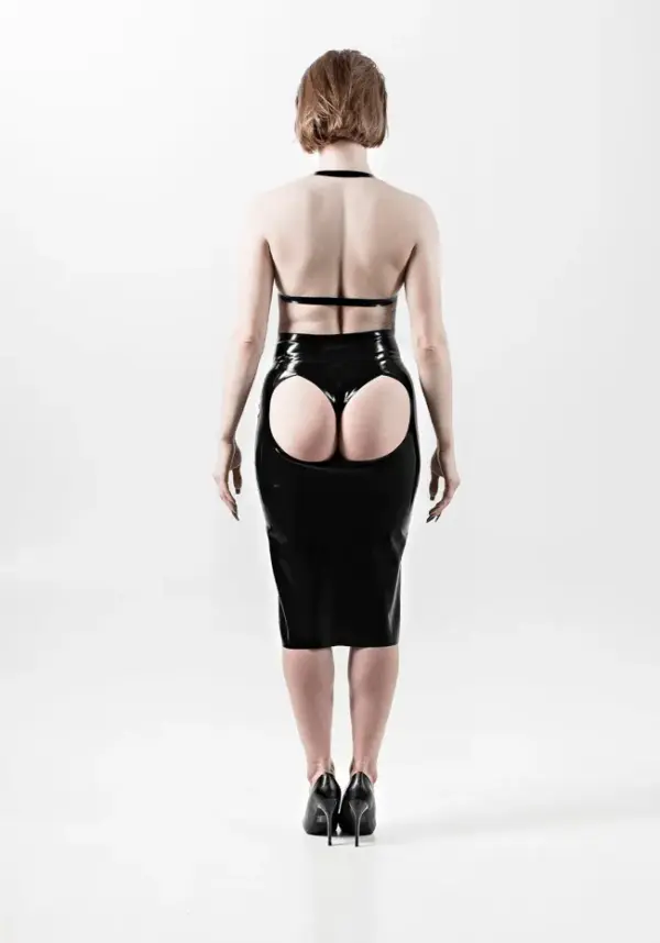 Model wearing tight rubber midi skirt with daring butt cutout and sleek fit