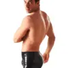Side view of form fitting latex shorts for men black rubber underwear