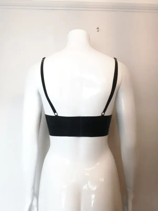 Mannequin wearing minimalist rubber fetish bra showing adjustable straps and soft cups