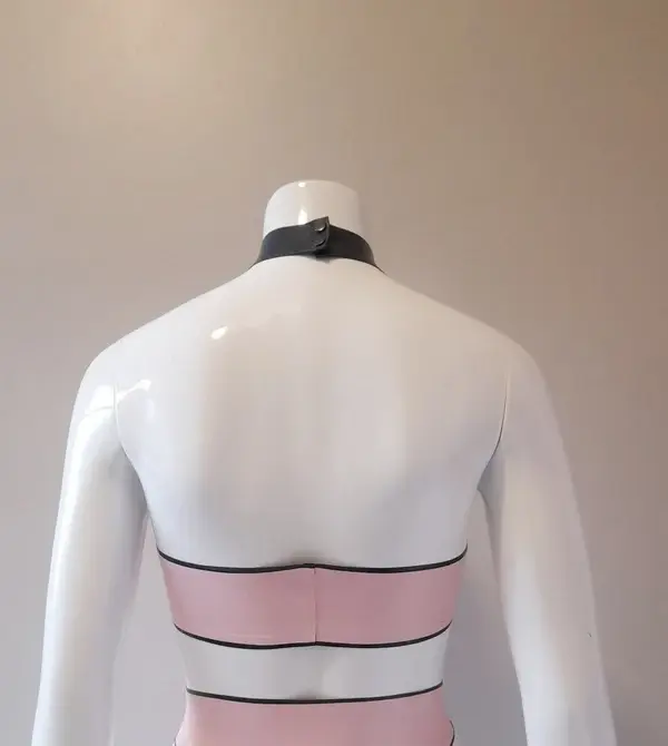 Model wearing pastel goth rubber fetish halter top showing underboob cut and snap collar