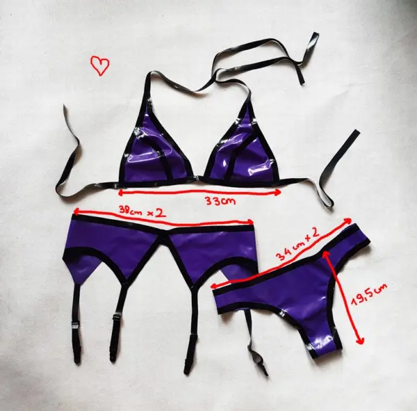 Model wearing complete 3 piece rubber fetish outfit showing adjustable ties and suspender clips