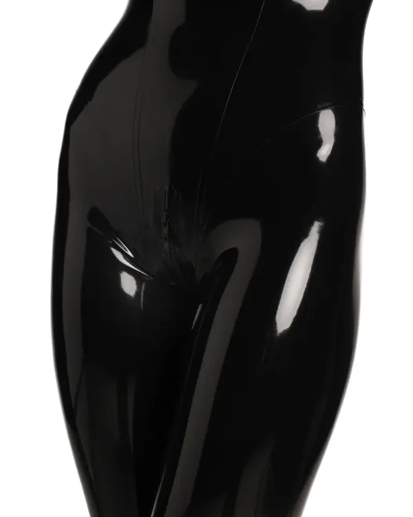 Close-up detail of black latex catsuit showing high gloss finish and form-fitting hip silhouette