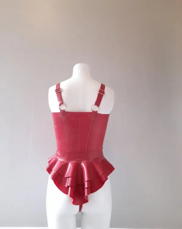 Model wearing figure flattering rubber fetish 3 piece suit showing waist cinching peplum belt and metal adjusters